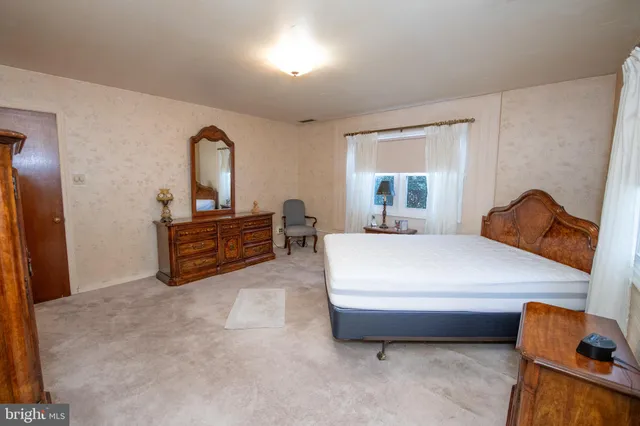 a bedroom with a bed and a mirror