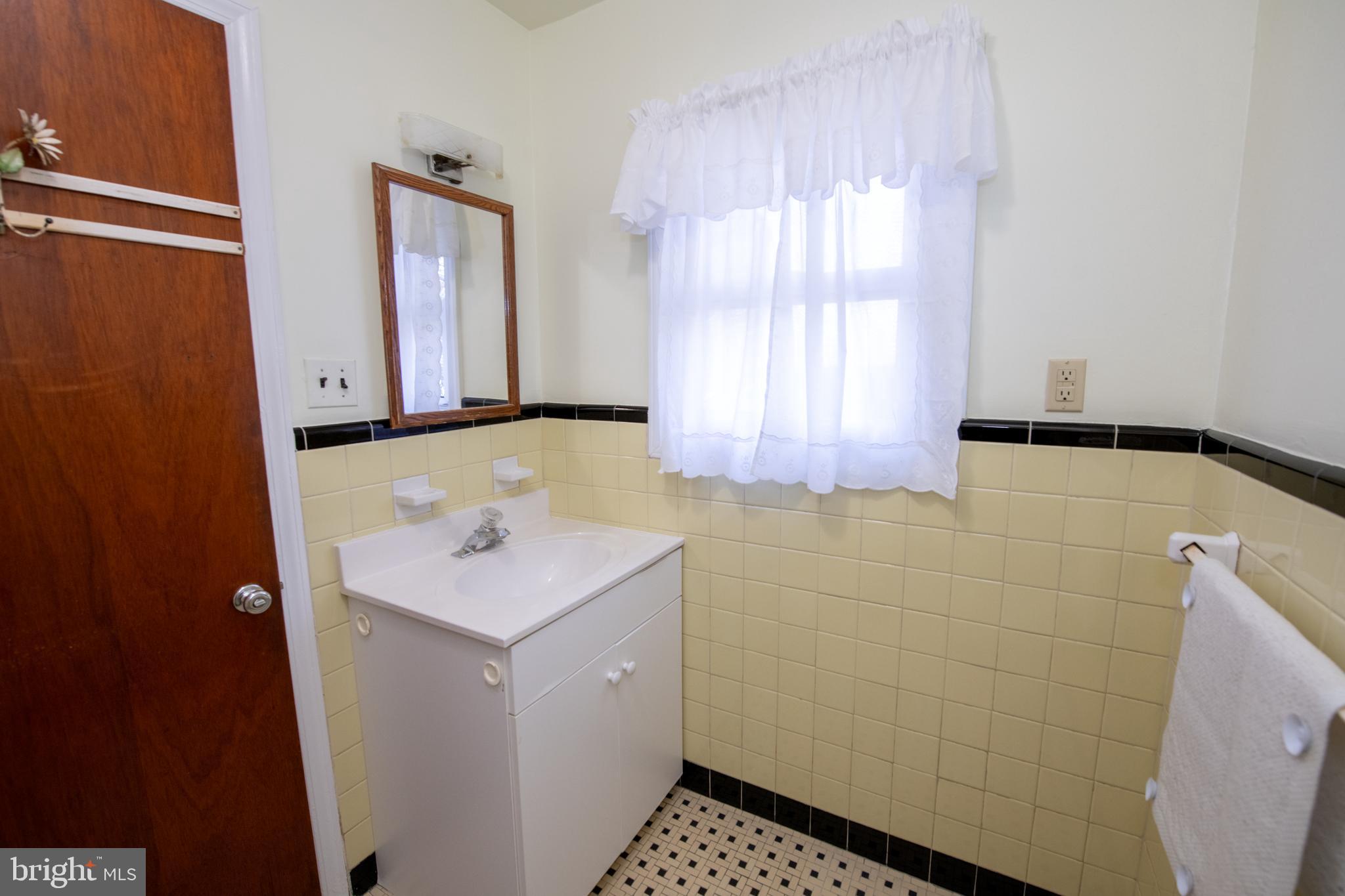 8810 Tyson Road Glenside, PA 19038 - Photo 23 of 53 a bathroom with a sink a toilet and window