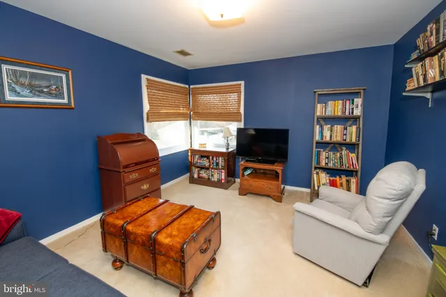 a view of a livingroom with workspace and a couch