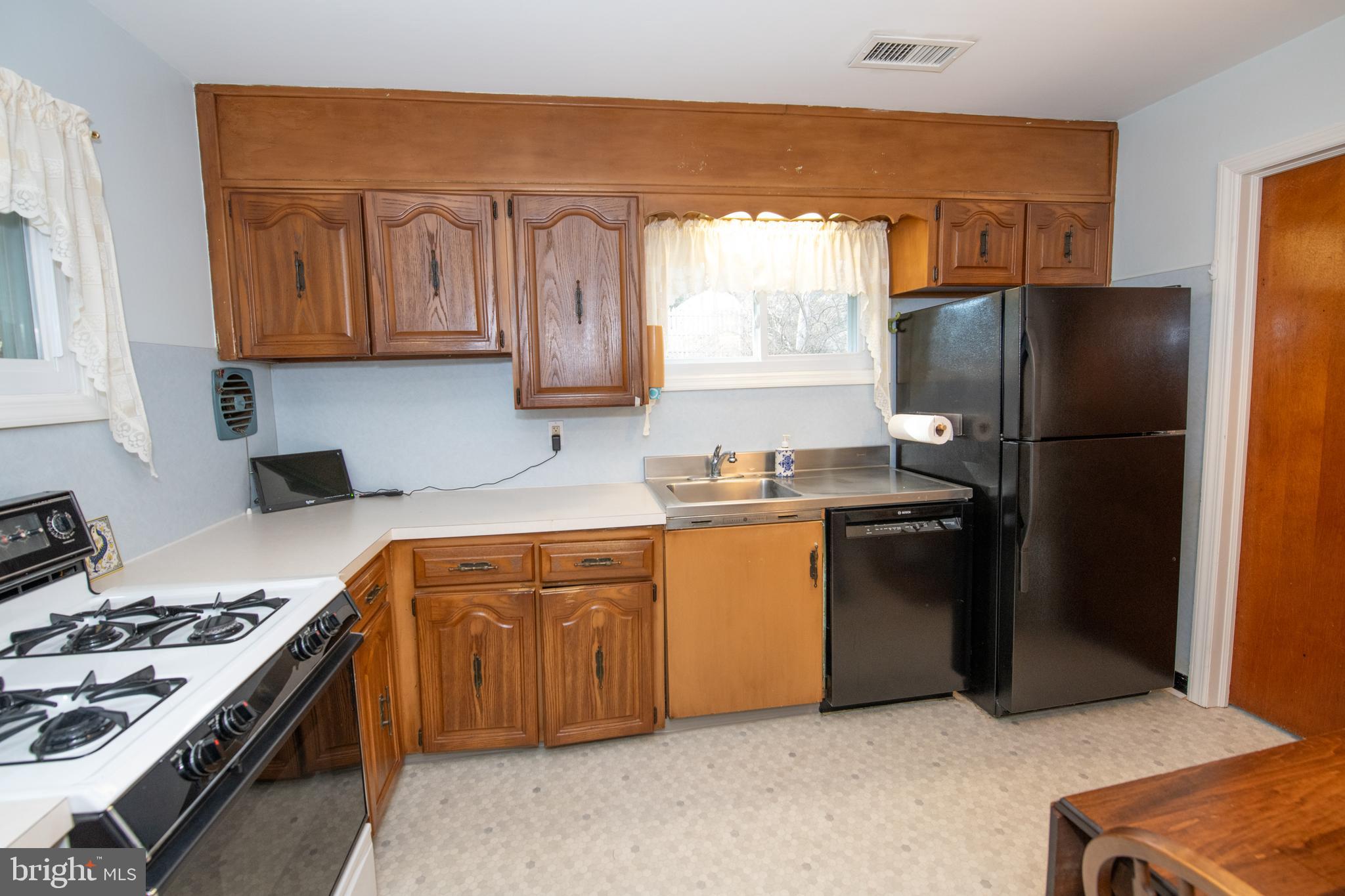 8810 Tyson Road Glenside, PA 19038 - Photo 37 of 53 a kitchen with granite countertop a refrigerator stove and sink