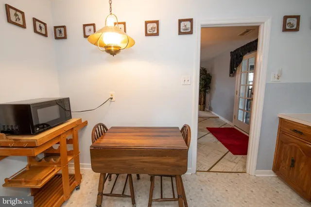 a dining room with furniture and chandelier