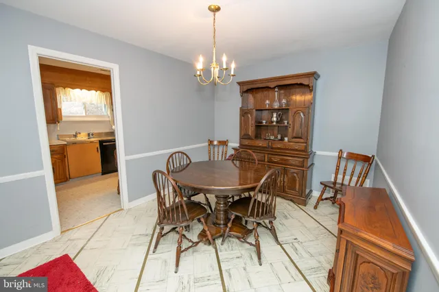 a view of a dining room with furniture and chandelier