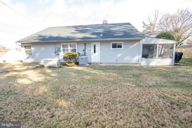 a front view of house with yard outdoor seating and barbeque oven