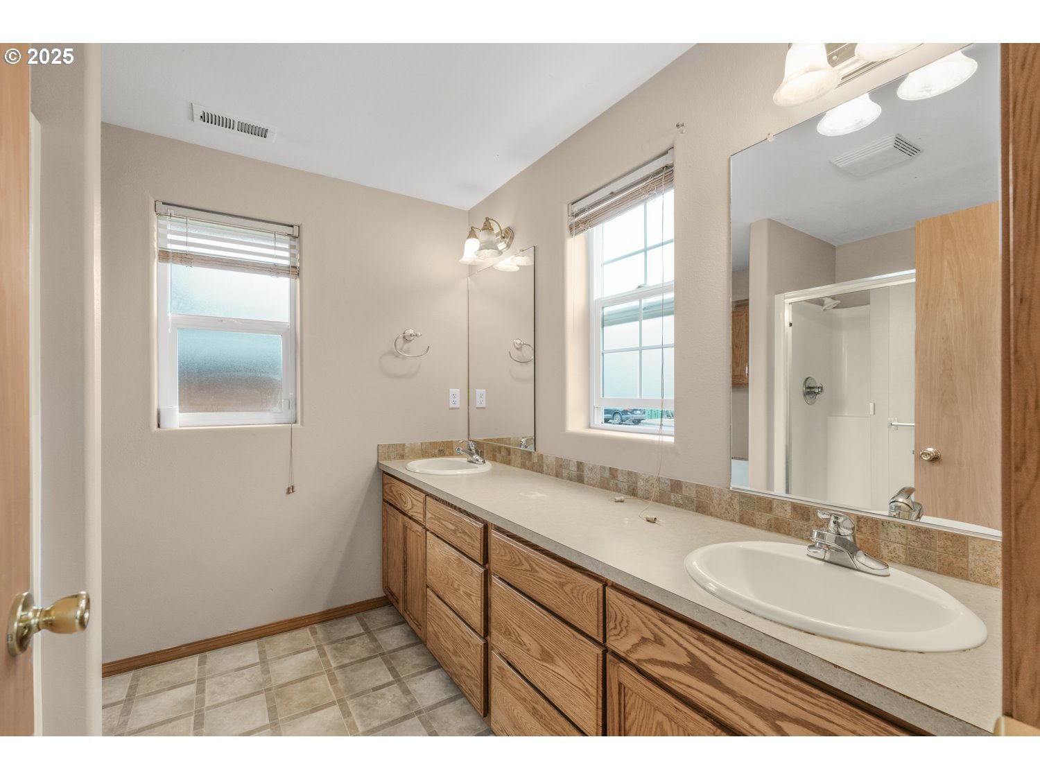 52269 Southeast Tyler Street Scappoose, OR 97056 - Photo 13 of 21 a bathroom with a sink double vanity granite and a mirror