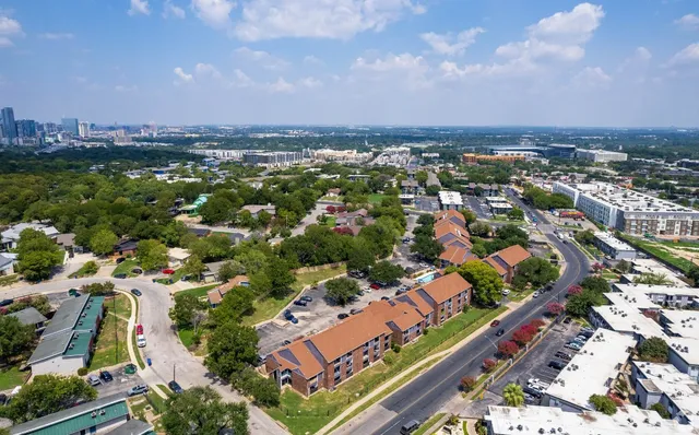 an aerial view of residential houses with outdoor space