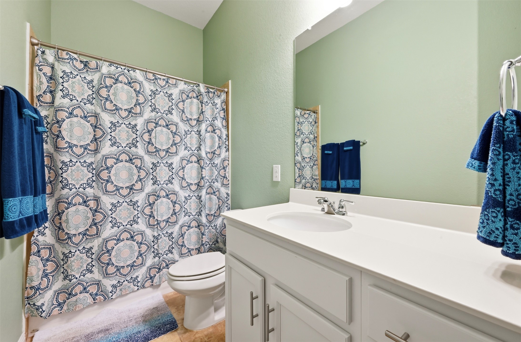 13116 Alans Way Manchaca, TX 78652 - Photo 21 of 25 Bathroom featuring a single vanity with an integrated sink, polished chrome faucet, and a large wall-mounted mirror