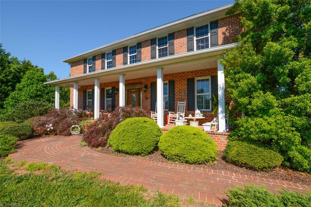 1141 Winding Ridge Road Walnut Cove, NC 27052 - Photo 2 of 30 Entrance with brick sidewalk and rocking chair front porch.