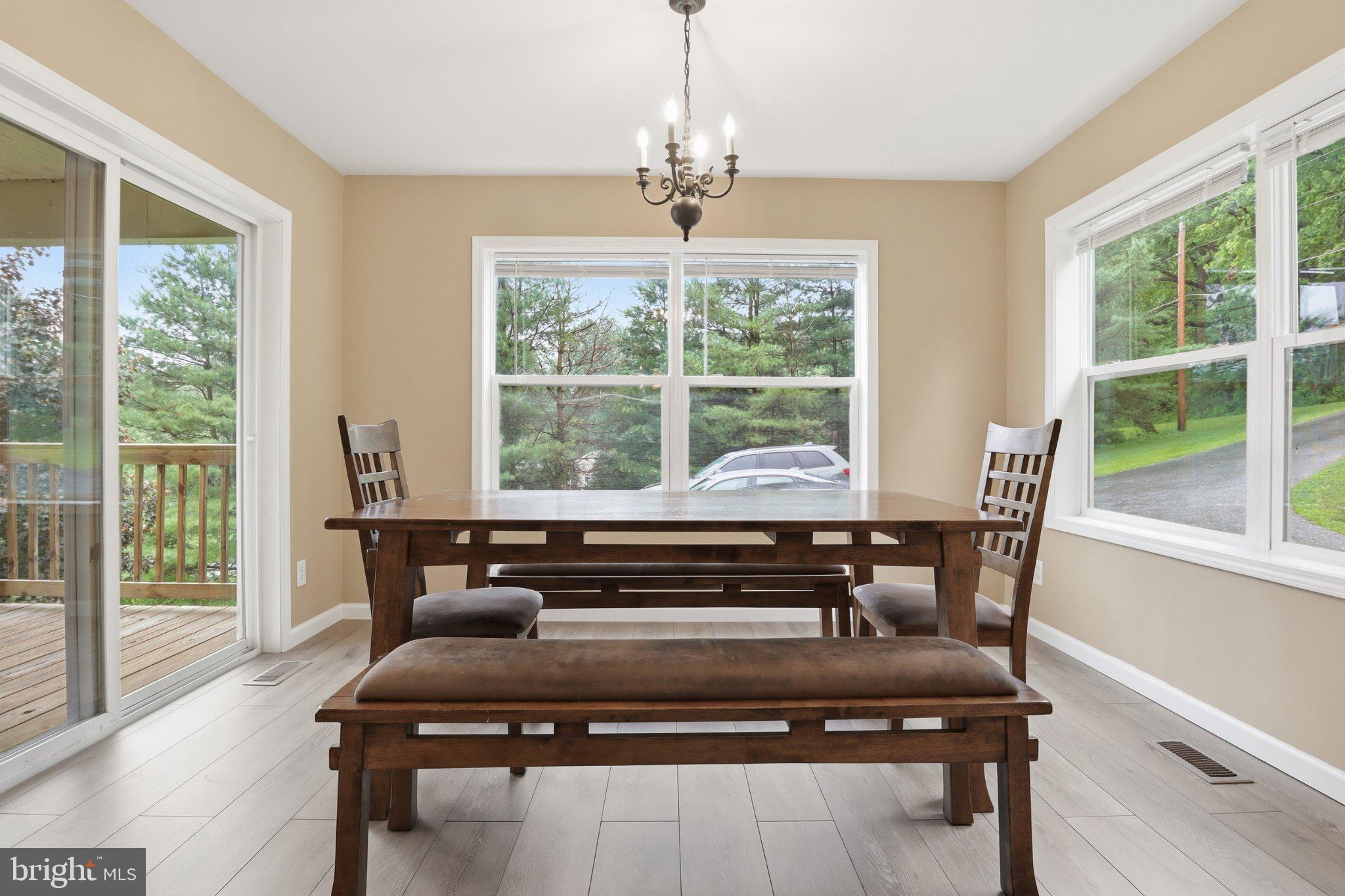 491 Garvine Mill Road Fawn Grove, PA 17321 - Photo 12 of 47 a view of a dining room with furniture a chandelier and wooden floor