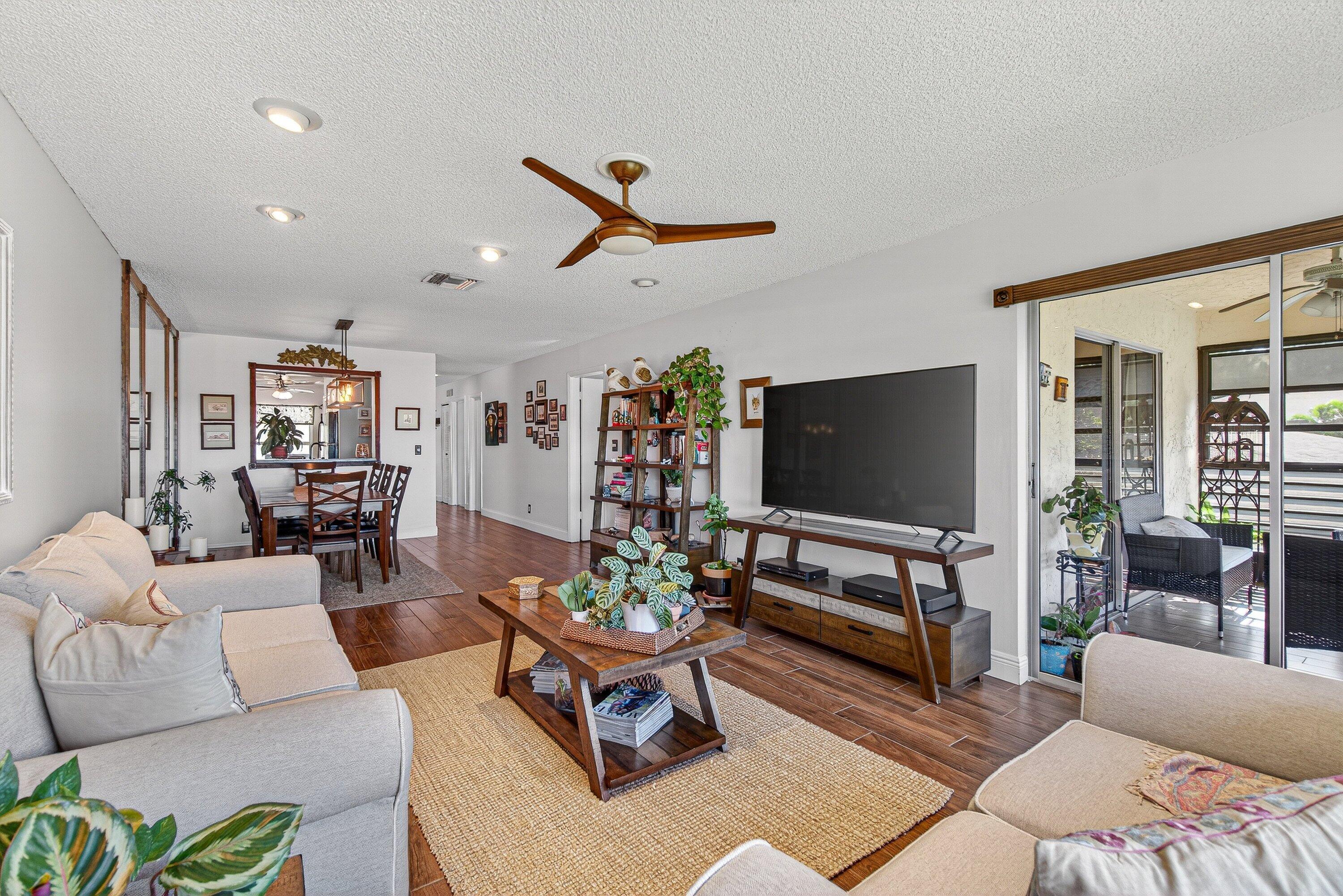 13465 Fishtail Palm Court, Unit D Delray Beach, FL 33484 - Photo 14 of 29 a living room with furniture and a flat screen tv
