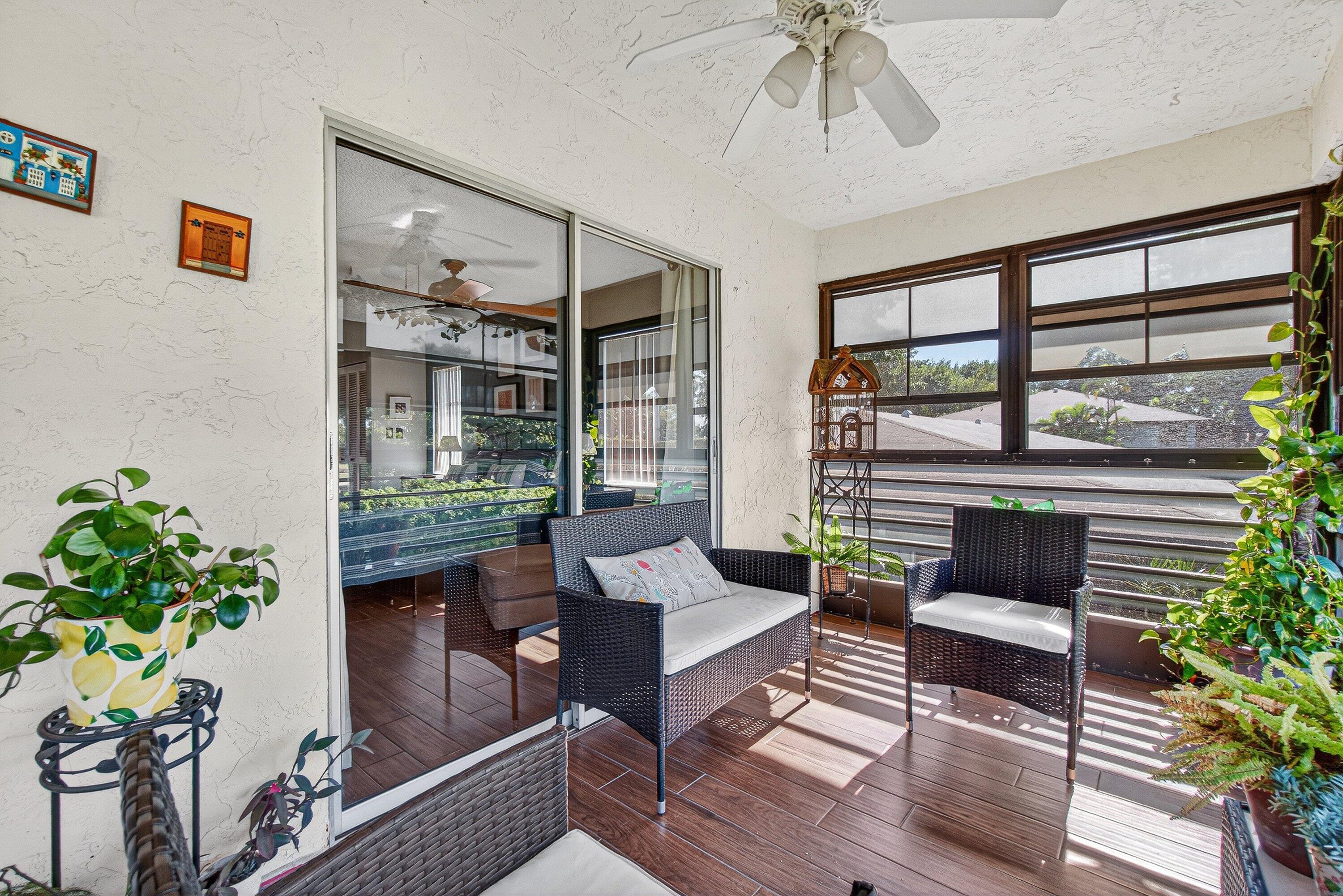13465 Fishtail Palm Court, Unit D Delray Beach, FL 33484 - Photo 23 of 29 a living room with furniture and a potted plant