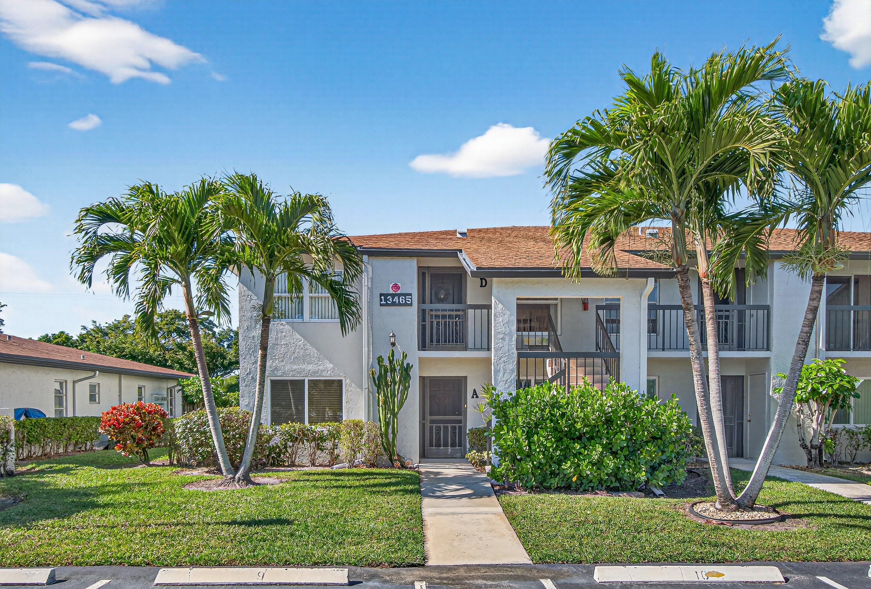 13465 Fishtail Palm Court, Unit D Delray Beach, FL 33484 - Photo 25 of 29 a front view of house with yard and green space