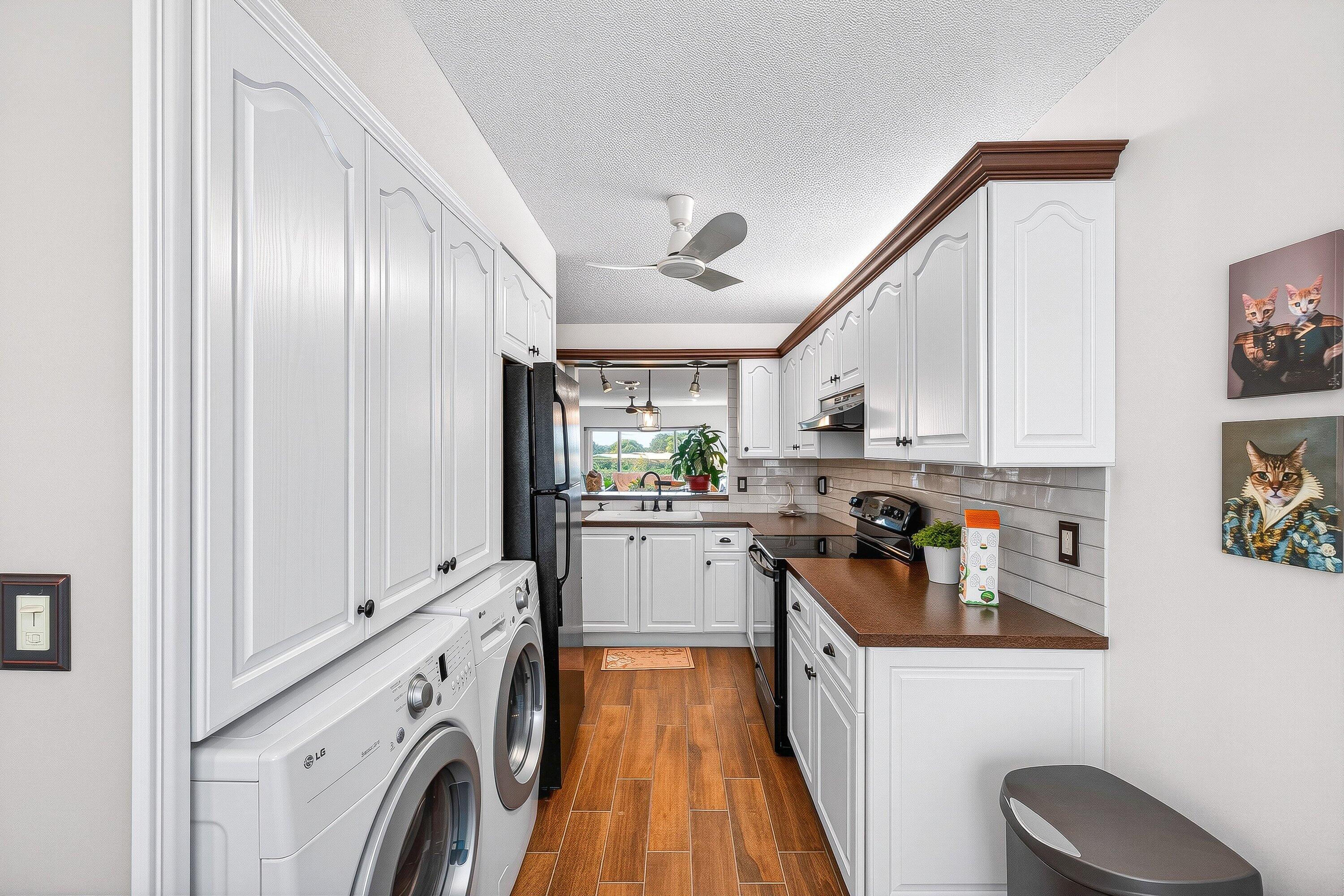 13465 Fishtail Palm Court, Unit D Delray Beach, FL 33484 - Photo 3 of 29 a kitchen with cabinets a sink and appliances