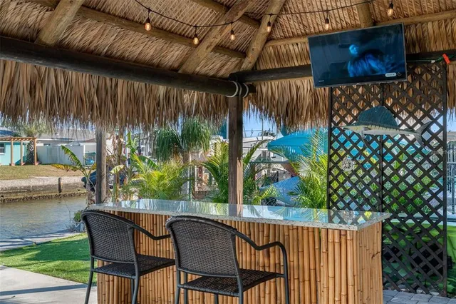 a view of a chairs and table in patio with wooden fence