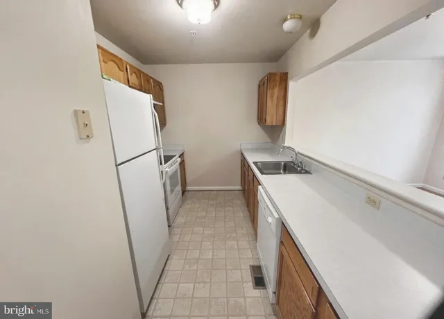 a kitchen with a sink a refrigerator freezer and a stove