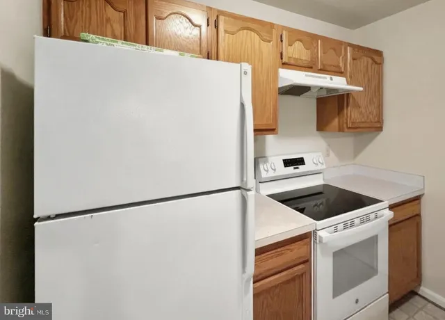 a kitchen with a refrigerator and a stove