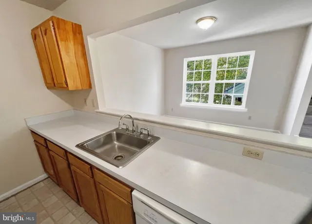 a kitchen with a sink and a window
