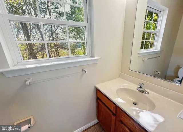 a bathroom with a sink and a window