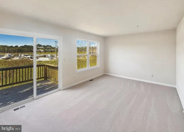 an empty room with sliding door and wooden floor