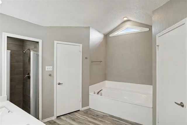 a bathroom with a bathtub and shower
