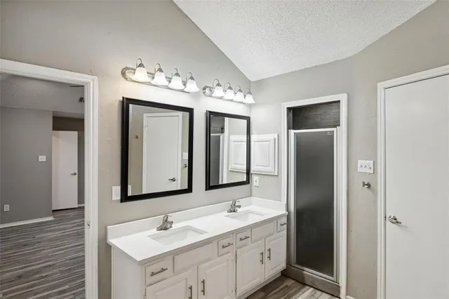 a bathroom with a double vanity sink and a mirror