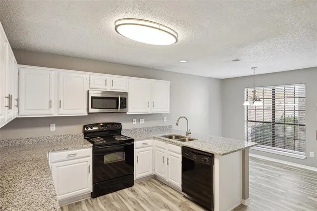 a kitchen with a sink stove and microwave