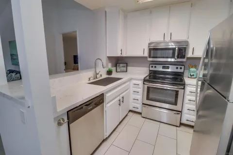 a kitchen with stainless steel appliances and white cabinets
