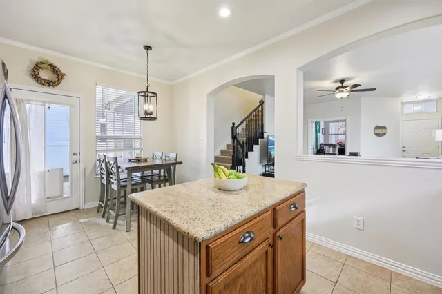 a kitchen with a table chairs and refrigerator