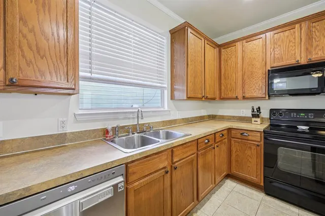 a kitchen with a sink stove and microwave