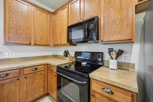 a kitchen with stainless steel appliances a stove a microwave and cabinets
