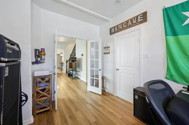 a view of a hallway with wooden floor and furniture
