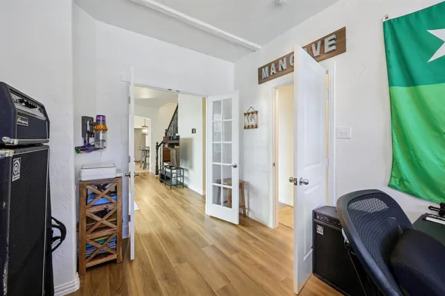 a view of a hallway with wooden floor and furniture
