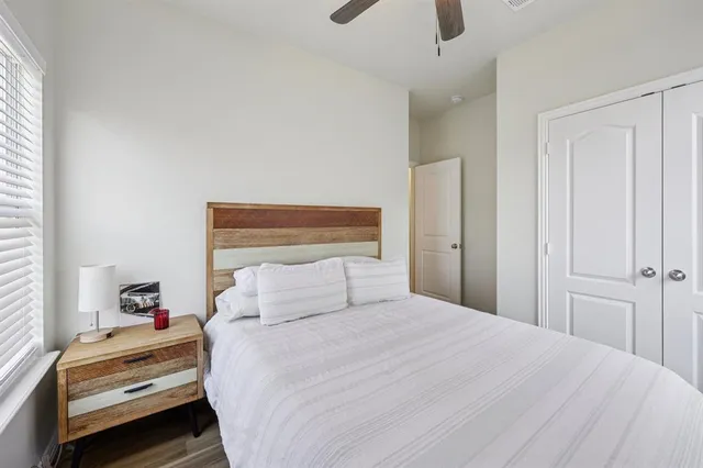 a bedroom with a bed and a window