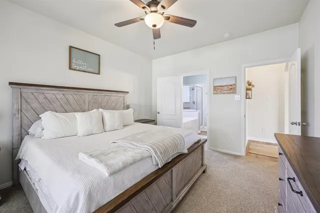 a spacious bedroom with a bed and a chandelier