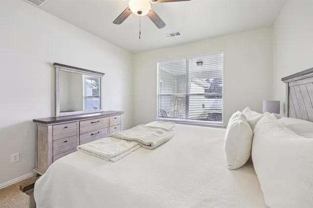 a bedroom with a bed and a mirror