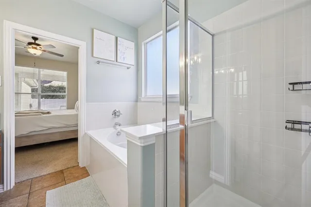 a bathroom with a tub a sink and mirror