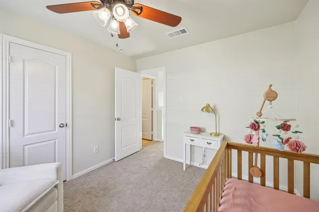 a bedroom with furniture and baby crib