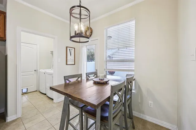 a view of a dining room with furniture and chandelier