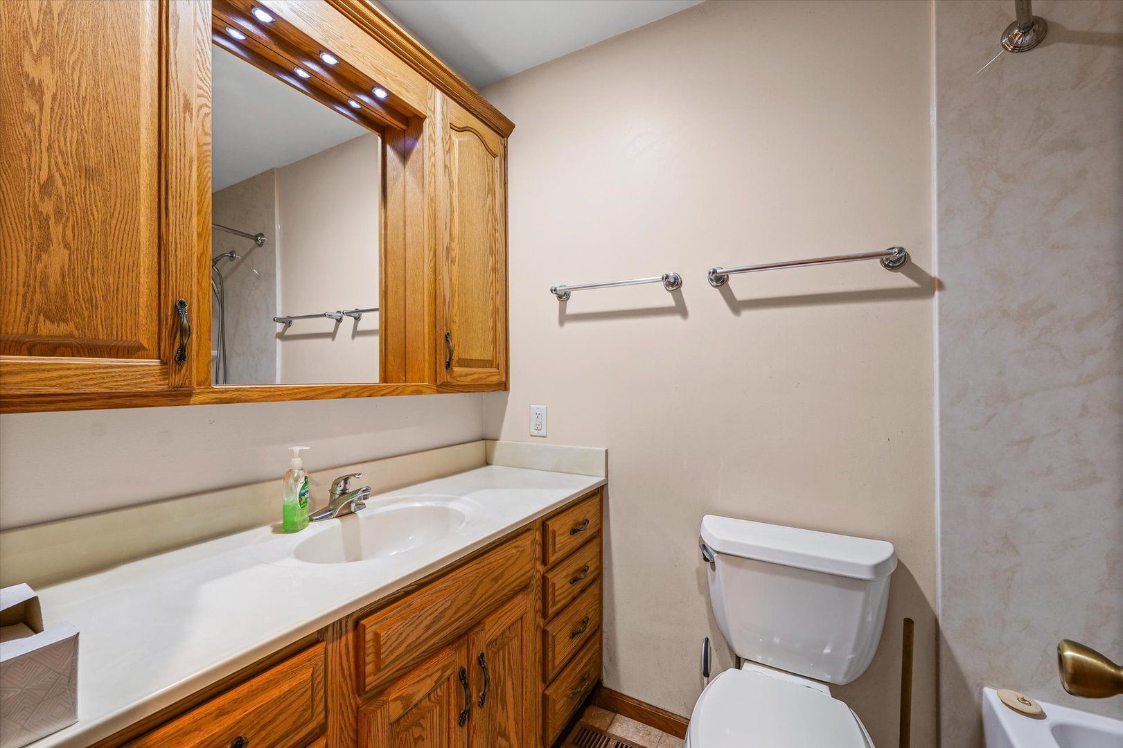 2801 West William Street Champaign, IL 61821 - Photo 13 of 30 a bathroom with a sink a toilet and mirror