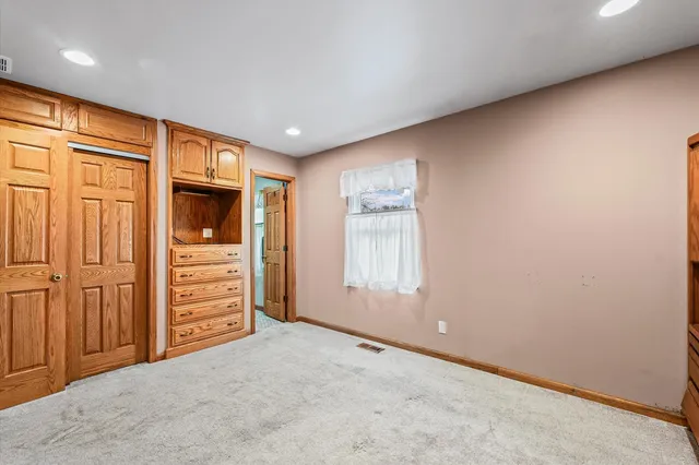 an empty room with closet area