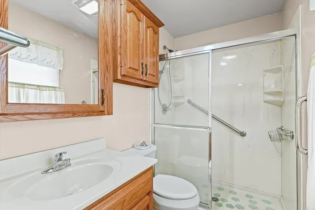 a bathroom with a sink toilet and shower