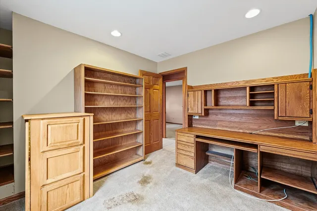 a hallway view with wooden floor and furniture