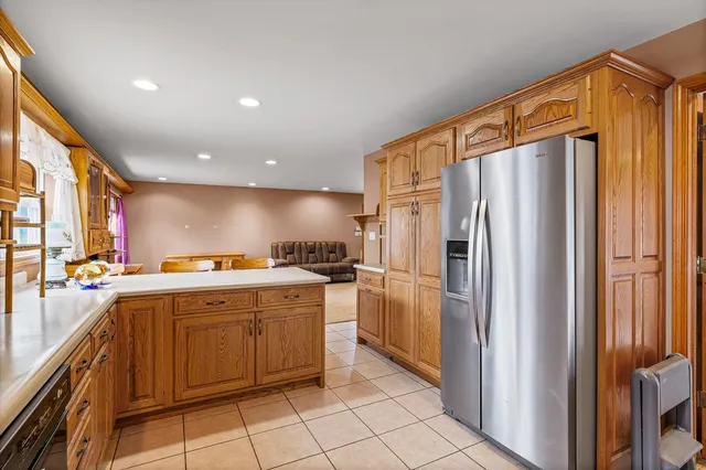 a kitchen with stainless steel appliances a refrigerator and a stove top oven