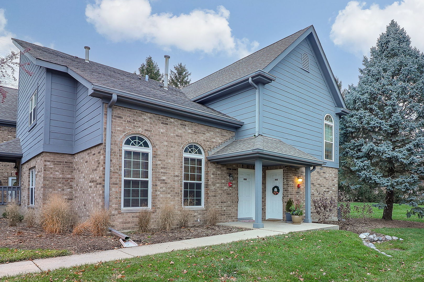 43 Foxcroft Road, Unit 203 Naperville, IL 60565 - Photo 1 of 19 a front view of a house with a yard and garage