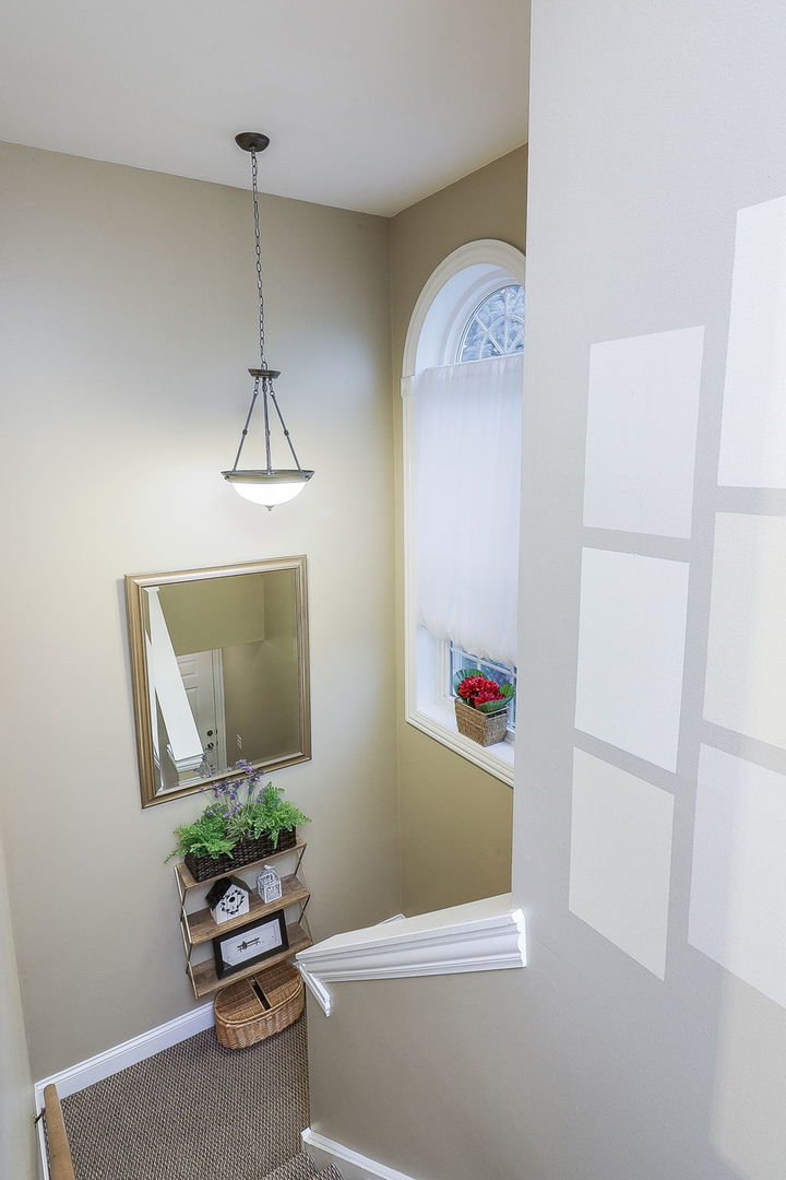 43 Foxcroft Road, Unit 203 Naperville, IL 60565 - Photo 2 of 19 a room with painting on the wall and a potted plant