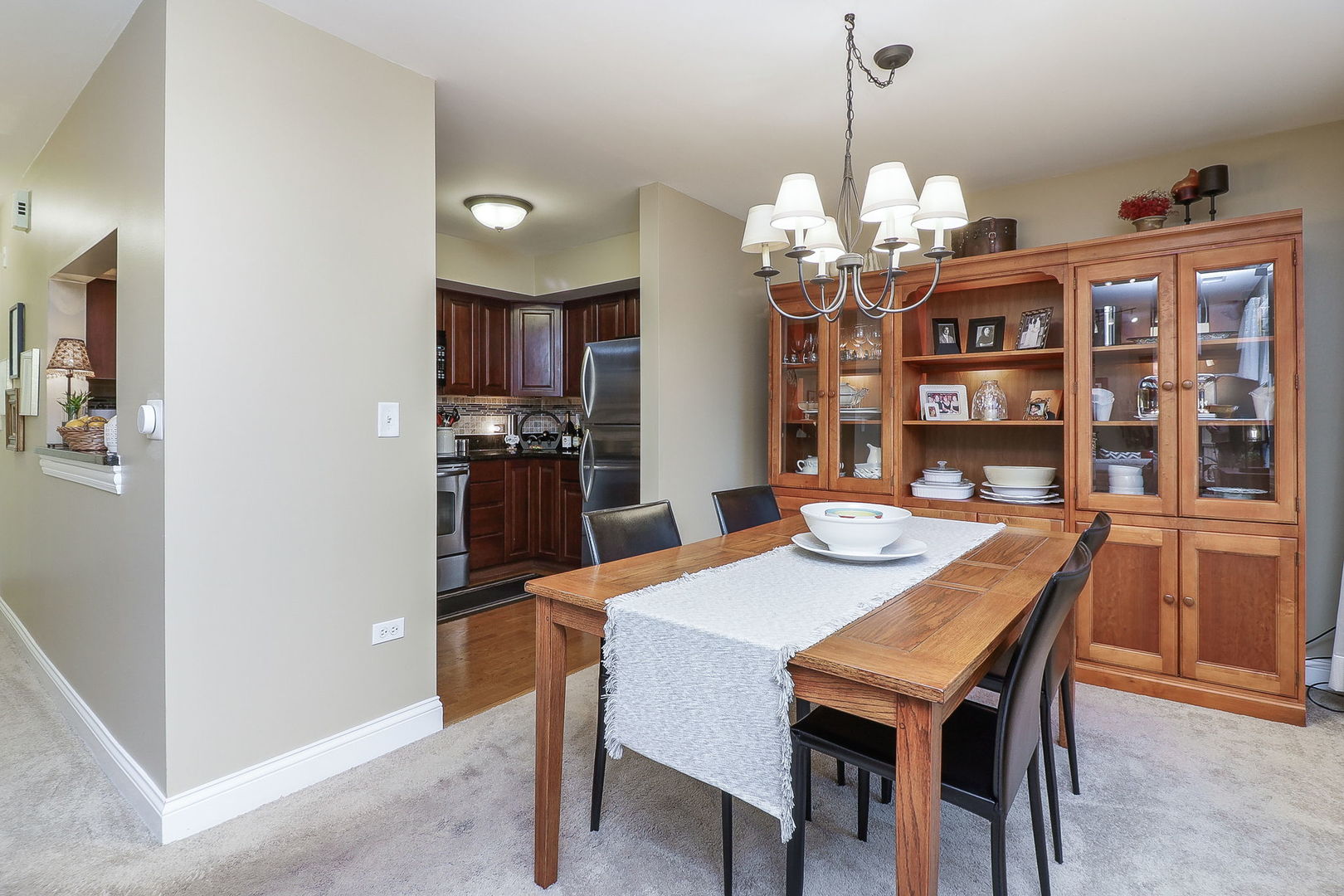 43 Foxcroft Road, Unit 203 Naperville, IL 60565 - Photo 8 of 19 a view of a dining room with furniture a chandelier and wooden floor