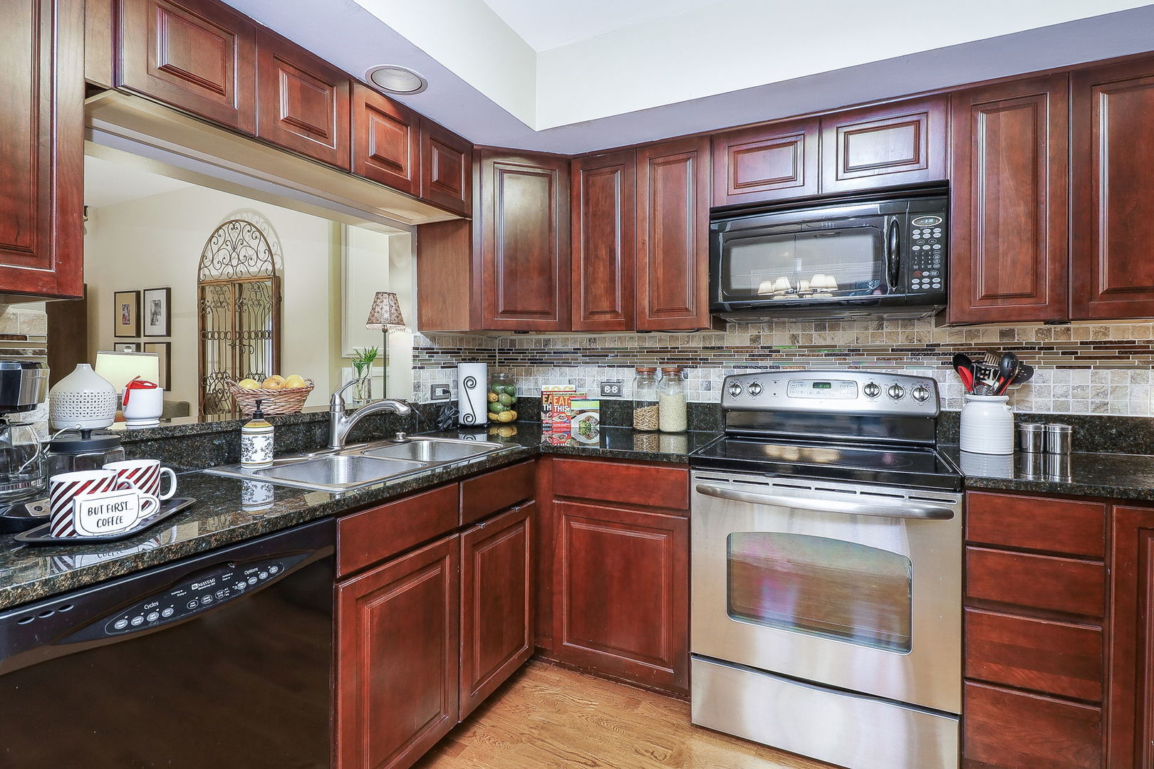 43 Foxcroft Road, Unit 203 Naperville, IL 60565 - Photo 9 of 19 a kitchen with stainless steel appliances granite countertop a stove a sink and a microwave