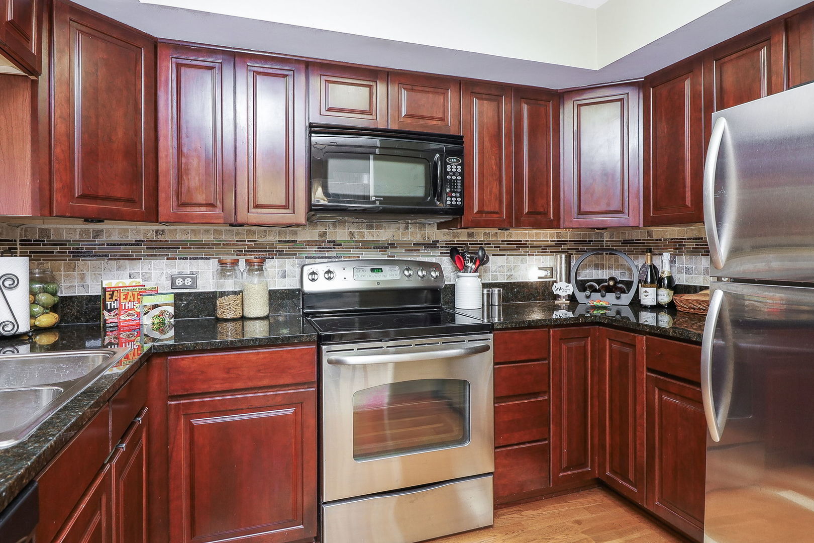 43 Foxcroft Road, Unit 203 Naperville, IL 60565 - Photo 10 of 19 a kitchen with stainless steel appliances granite countertop wooden cabinets a stove top oven a sink and dishwasher