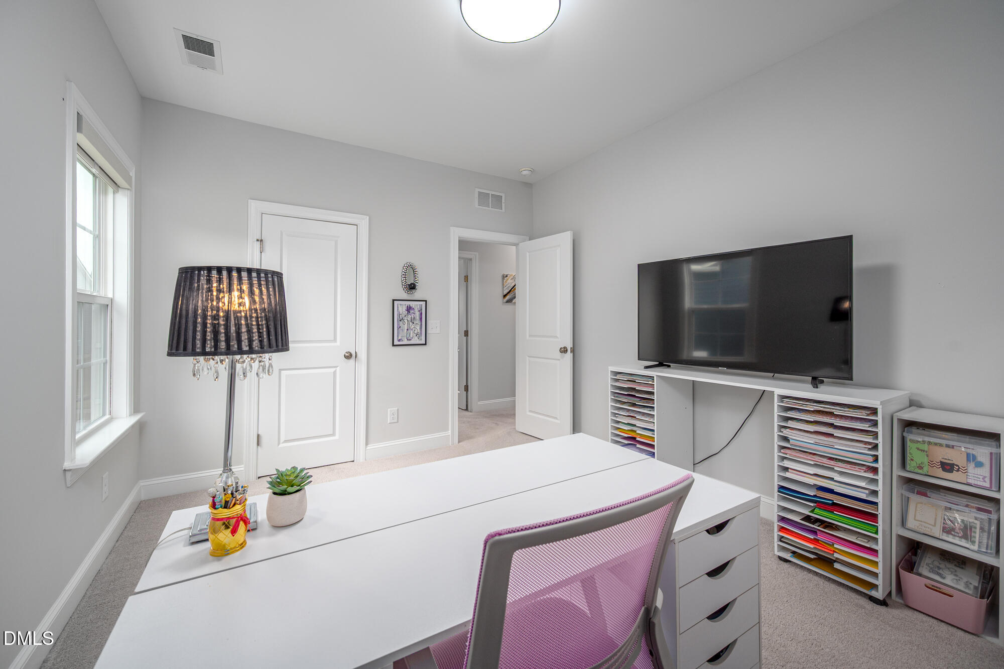 319 High Woods Ridge Chapel Hill, NC 27517 - Photo 33 of 71 a living room with a flat screen tv and a refrigerator