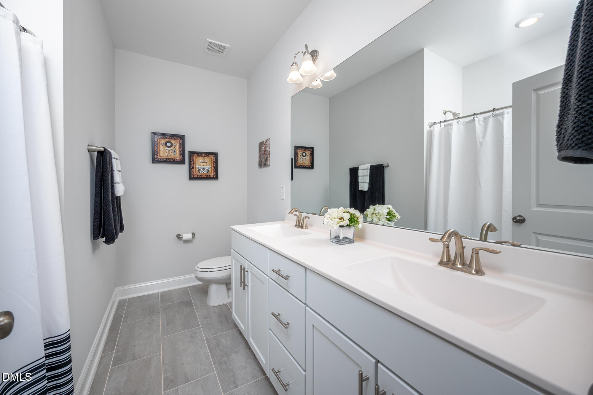 319 High Woods Ridge Chapel Hill, NC 27517 - Photo 34 of 71 a bathroom with a double vanity sink and mirror