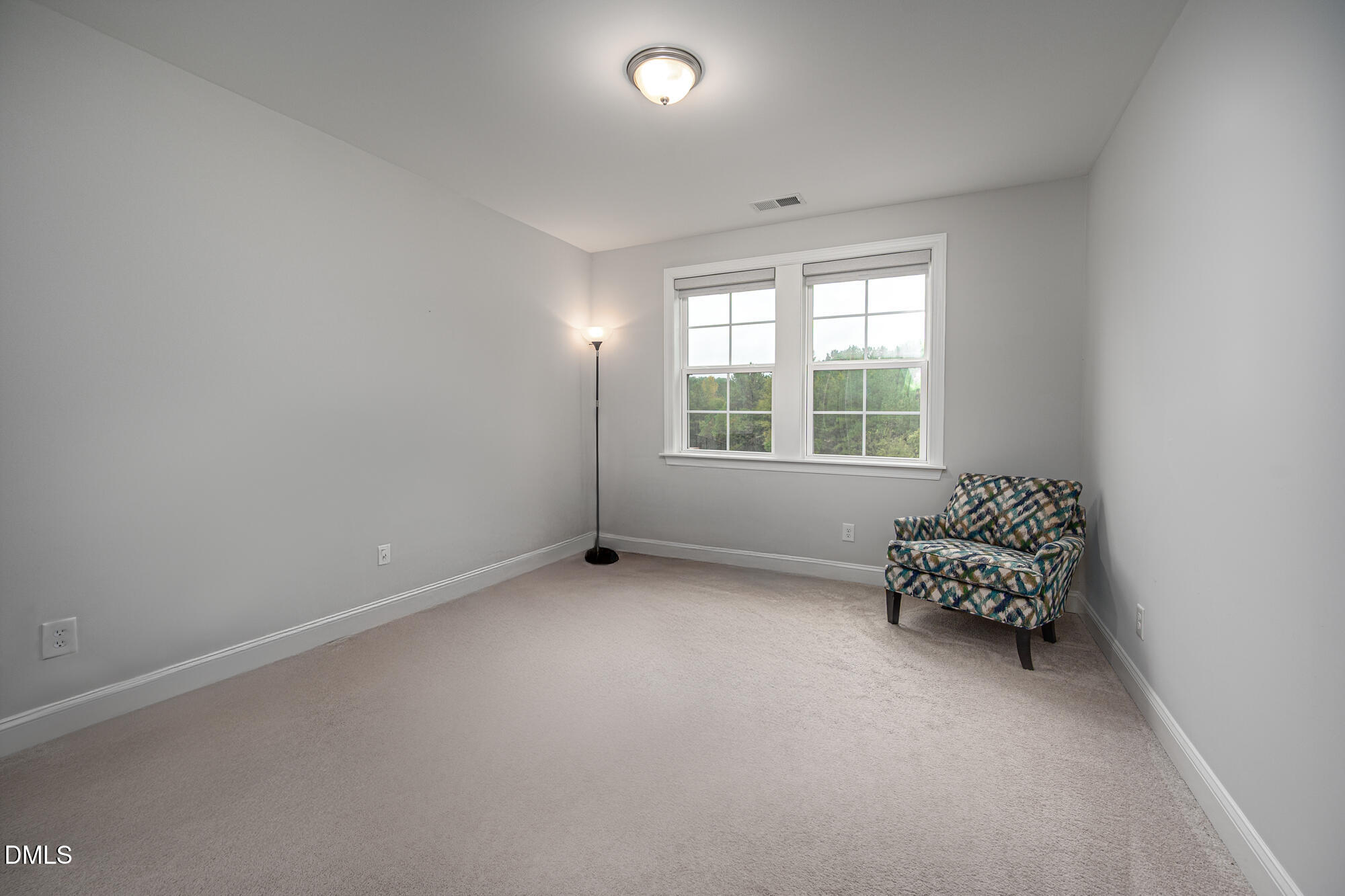 319 High Woods Ridge Chapel Hill, NC 27517 - Photo 41 of 71 an empty room with a chair and windows